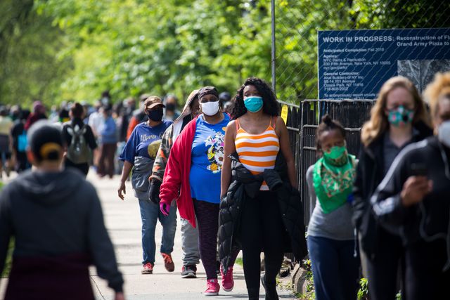 People wait in line to receive free face masks at the Prospect Park in the Brooklyn borough of New York, the United States, May 3, 2020.